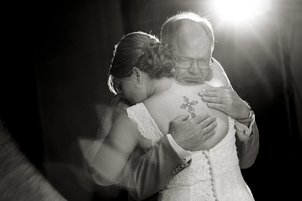 Father hugs bride with cross tattoo - wedding photo by Melissa Jill Photography